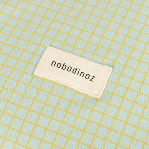 Matrizenhaus STORIES Limitierte Auflage - Bio-Baumwolljersey 50x70cm Nobodinoz grünes Zitronengitter